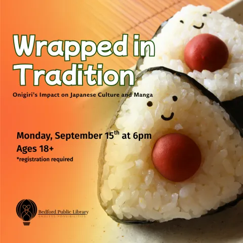 Two onigiri rice balls with a smiley face on the right hand side 