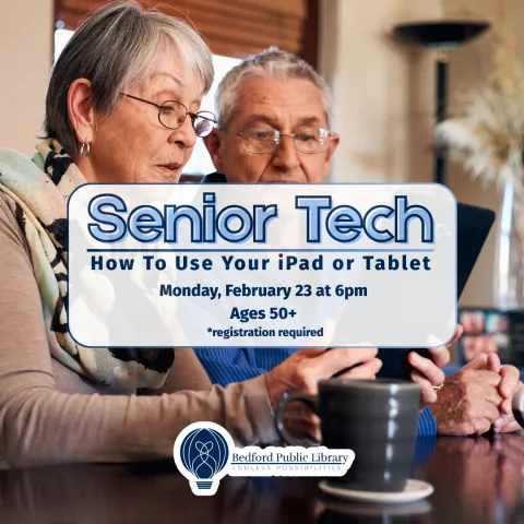 A picture of two senior citizens trying to work a tablet